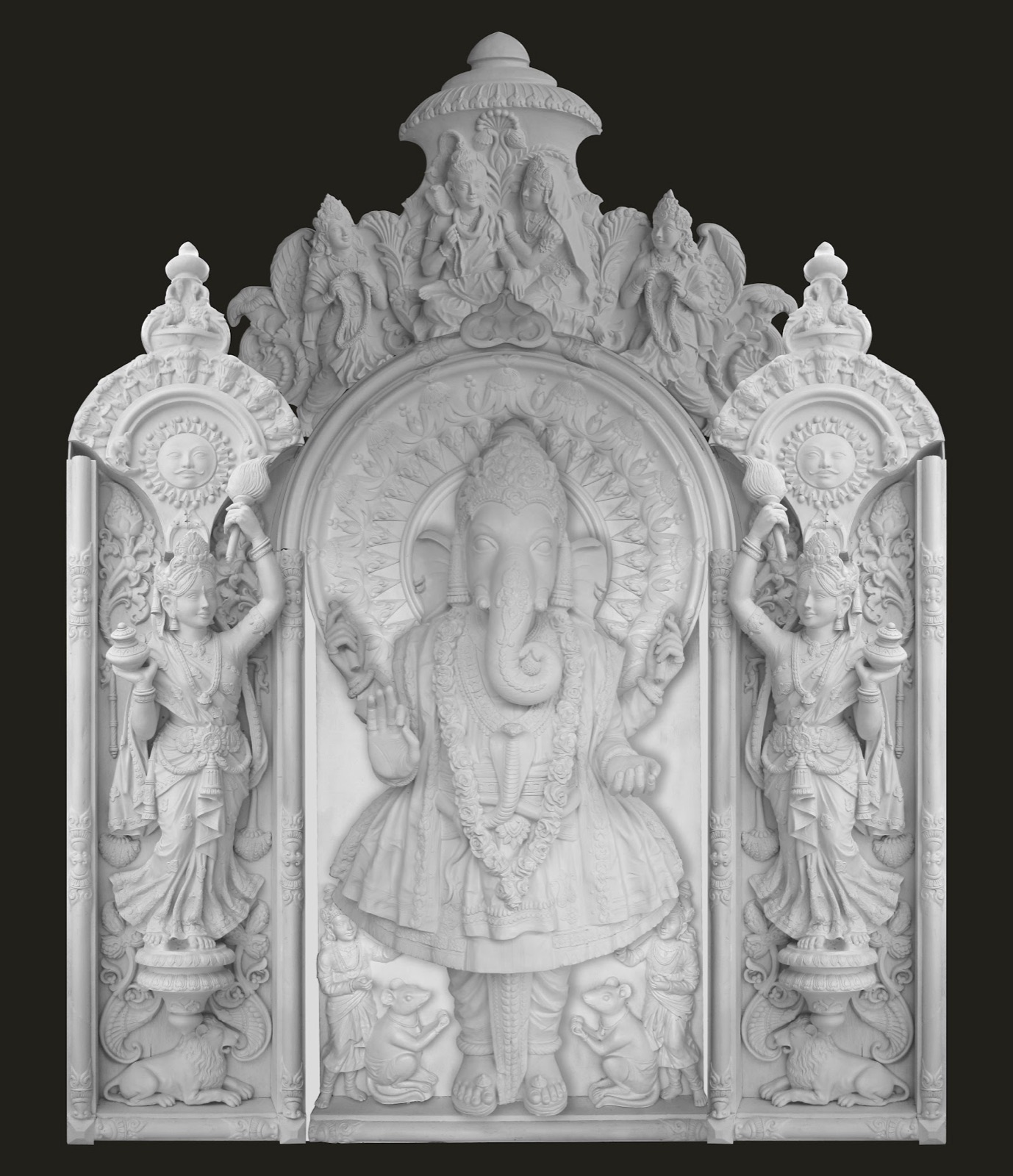 White relief panel of Lord Ganesha standing beneath a carved arch, flanked by two attendant figures
